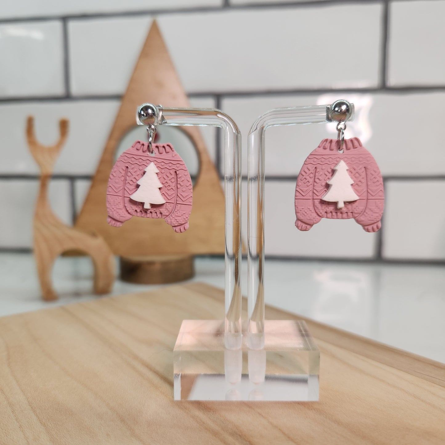 Christmas pink sweater earrings with a white Christmas tree.