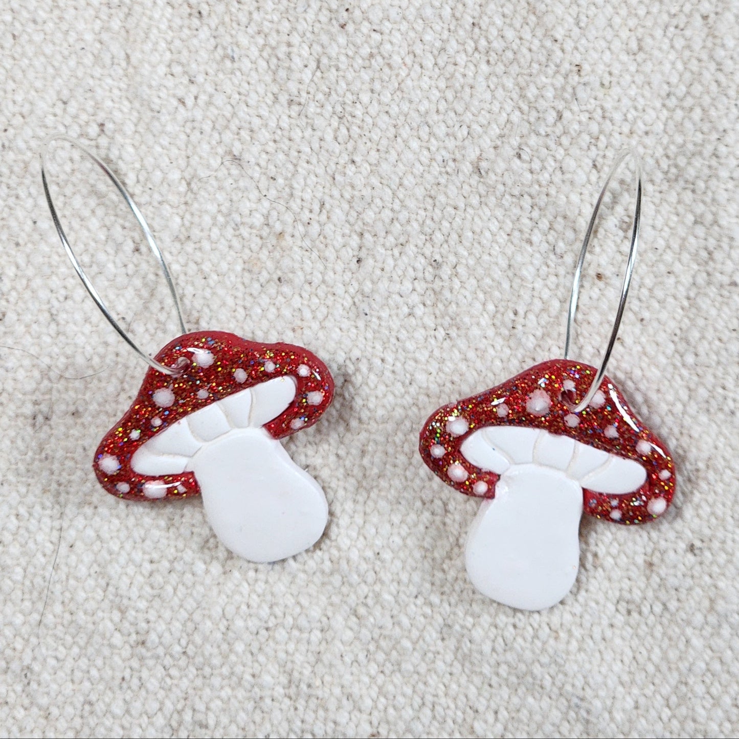 Mushroom earrings on hoops.