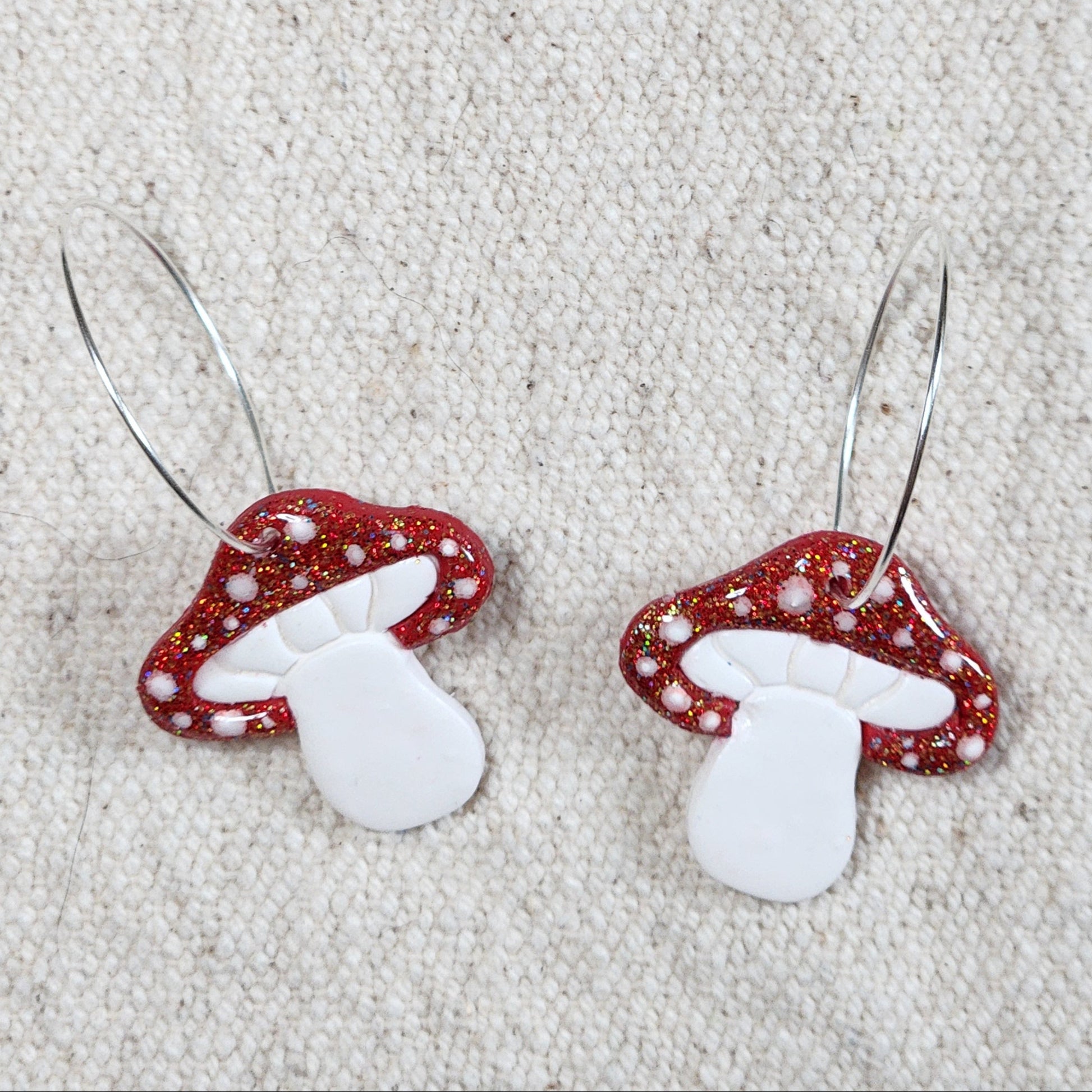 Mushroom earrings on hoops.