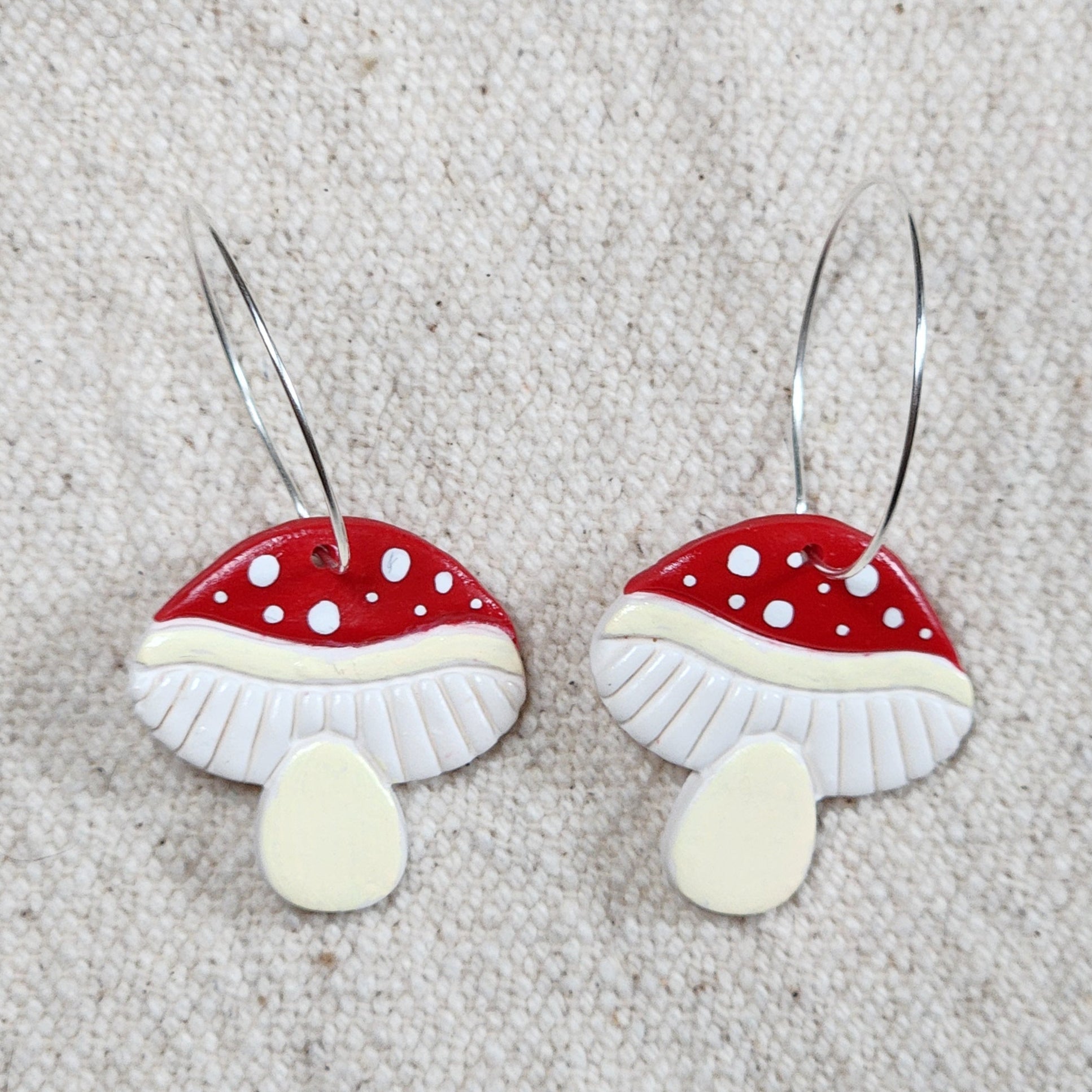 Mushroom Earrings on hoops.  Caps are matte red with white polka dots.